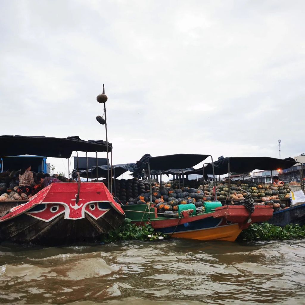 Des bateaux chargés de légumes au marché flottant